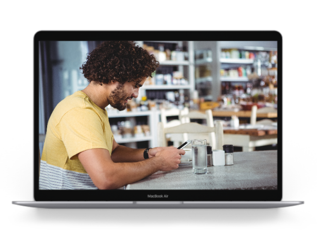 Man interacting with the EthOS mobile app during real-world product testing.